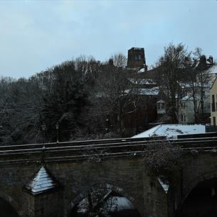 View of Durham Cathedral and Castle from Elvet Bridge in the snow: the historical heart of Durham.