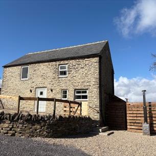 Front of barn with hot tub