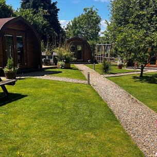 Camping pods, picnic bench, flowers