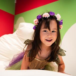 A little girl wearing a fairy outfit playing on squishees in Pippa Hale Pet Project