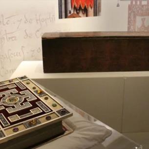 Decorative gospel book and coffin at Durham Cathedral Museum exhibition