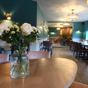 Restaurant table with a vase of white flowers