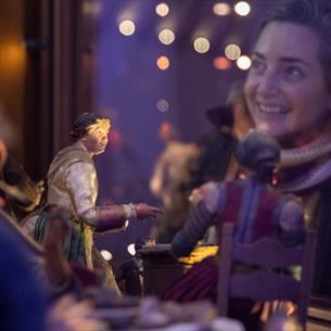 A woman looking at the Neapolitan Nativity scene at The Faith Museum, Auckland Palace