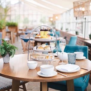 The Glass House restaurant with a table set for afternoon tea.