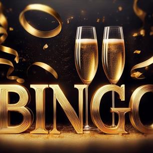 Two glasses of champagne with a stand spelling out BINGO in gold letters and gold ribbon.