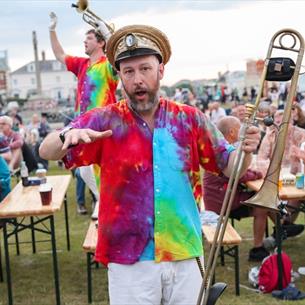 Musicians dancing and playing for the crowd at Seaham Brass Bash - Durham Brass Festival in 2025.