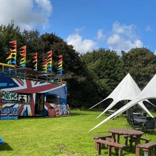 Grounds of Ushaw set up with picnic benches and tents in the sunshine