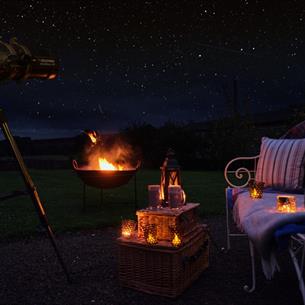 Outdoor seating, fire pit, picnic hamper, a starry dark sky