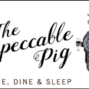 Image of a pig dressed impeccably.