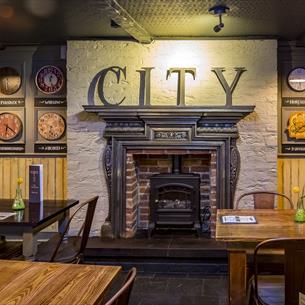 A fireplace with City written above it