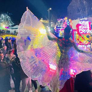 Crowds enjoying fairground rides and performances in Sacriston.
