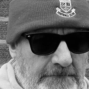 Close up shot of Andy Gilbert's face in black and white. 
