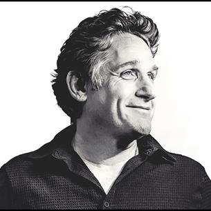 Black and white photo of Tom Stade looking off to the left.