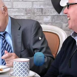 Two gentleman enjoying each other's company over tea and refreshments.