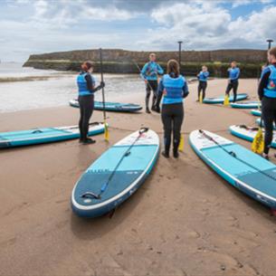 Adults preparing for a SUP lesson at Seaham Harbour Marina