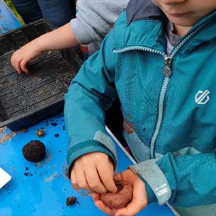 child with seeds in their hand