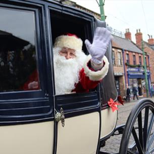 Father Christmas waving from a carriage at Beamish Museum.