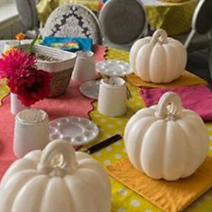 A colourful table prepared for Ceramic Pumpkin Painting.