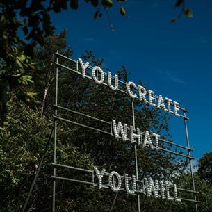 ©TheBowesMuseum
A structure in front of the trees with the words, 'You Create What You Will'.