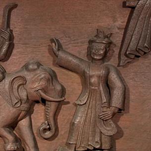 A wooden carving of a scene from the Ramayana.