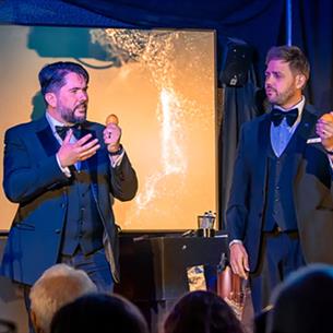 Tim Lichfield and Andy Larmouth, Magic Duo on stage holding eggs. 