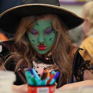 A little girl  wearing a handcrafted witch's hat. Hopetown Darlington.