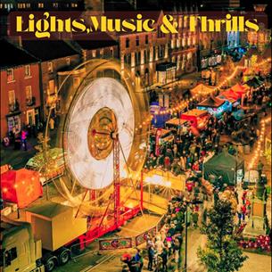 A carnival along a street with a Ferris Wheel, colourful stalls and bustling crowds.  