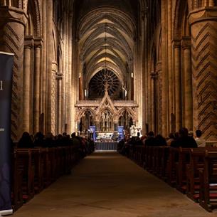 Speakers from Durham Cathedral Institute debate to an audience in the nave. 