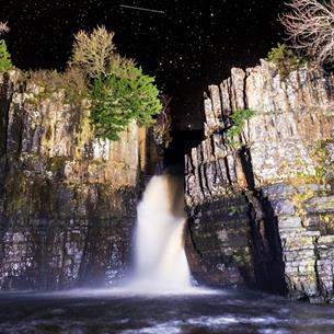 Family Stargazing. Starry night's sky over High Force Waterfall. 