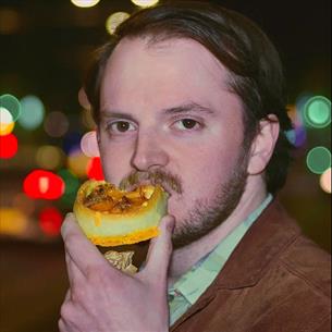 Headshot of Cobin Millage eating a snack