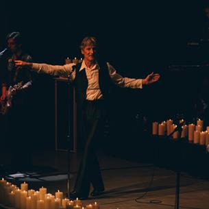 Bowie Tribute artists performing on a candlelit stage.