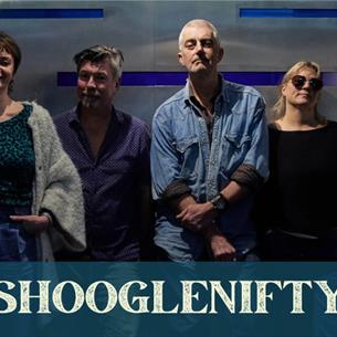Six people standing against a wall wearing blue tones, with the text 'Shooglenifty' at the bottom