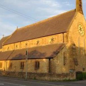 Exterior view of an ornate church in the sun.