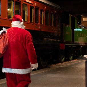 Santa walking through train carriages.