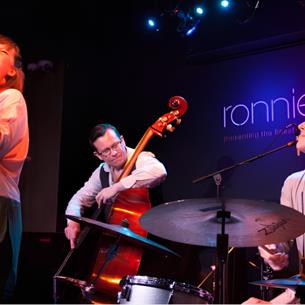 A jazz band playing on a colourful stage.