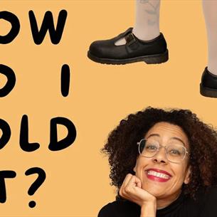 Yelloe background, with a person smiling in the bottom corner, text reading "How do I hold it?" on the left and a pair of legs wearing maryjane shoes