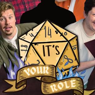Two people leaning either side of a large dice, carrying an old book and another dice, looking excited.