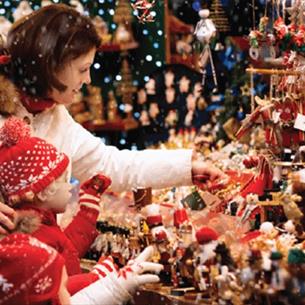 A family looking at a stall at the Beamish Hall Hotel Christmas Fair