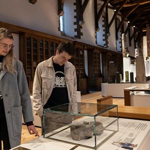 A couple looking at exhibitions inside Durham Cathedral Museum