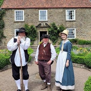 Pockerley at Beamish with three people dressed in period dress