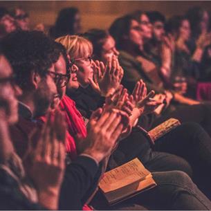 Image of a group of people at a Durham Book Festival event who are seated and clapping.
