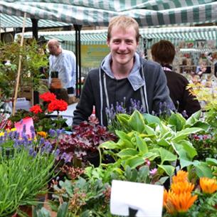 Man with flowers at Durham City Farmers' Market