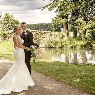 Two people in front of a lake