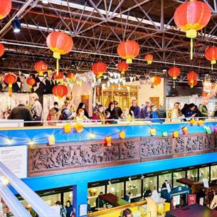 people standing under colourful lanterns as part of the Lunar New Year celebrations at Durham oriental Museum. 