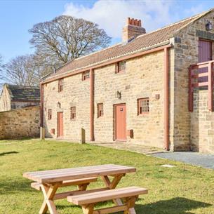 External view of Drovers Rest with picnic tables in the foreground
