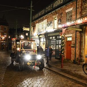 A Christmas evening at Beamish Museum with a vintage car and Christmas lights