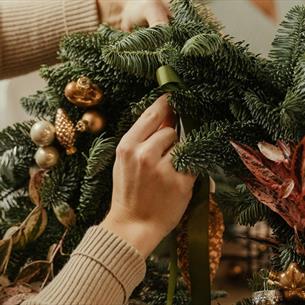 Someone making a Christmas Wreath
