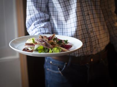 Waiter serving food at Lord Crewe Arms