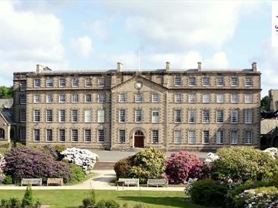 Exterior view of the front of Ushaw with Northern Saints Trails logo