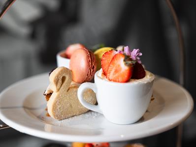 An example of the afternoon tea Café Bowes makes featuring macaroons, scones and swan style biscuit.